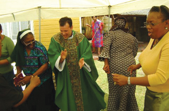 Missionary Father Dermot Roache, S.M.A. dances to South African music.