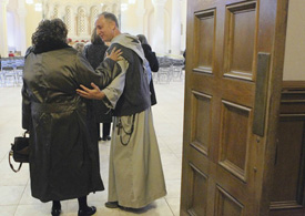 LOMBARDO escorts a guest into a benefit concert to raise funds for the Mission of Our Lady of the Angels.