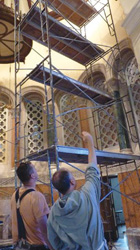 Father Bob Lombardo discusses the church’s renovations with a worker.