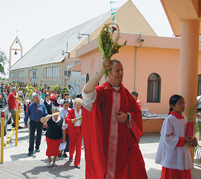 Herman leads a Palm Sunday procession