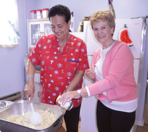 Muus and a volunteer prepare a meal at the Bernardine Center.