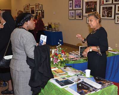 Cheryl Holley, director of the Josephite Pastoral Center in Washington, D.C., staffs a display table of resources specifically developed for the African-American community