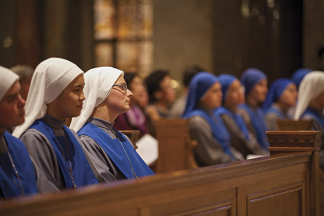 Sister Marie Protectrice de la Foi sits with another postulant who is about to take first vows.