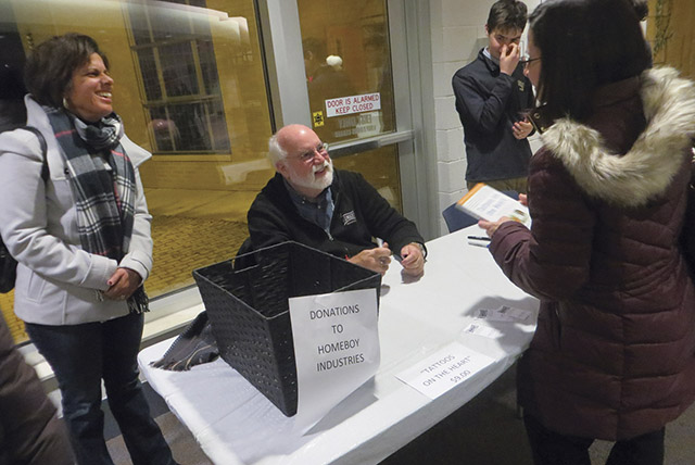 Boyle signs his book, Tattoos on the Heart(Free Press, 2010), after his talk in Toledo, Ohio.