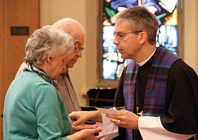 Father Kermit Holl, O.S.C. offers the sacrament of Anointing of the Sick.