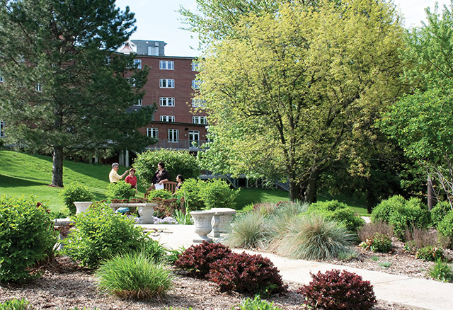 Visitors to the Weber Retreat and Conference Center chat in the garden.