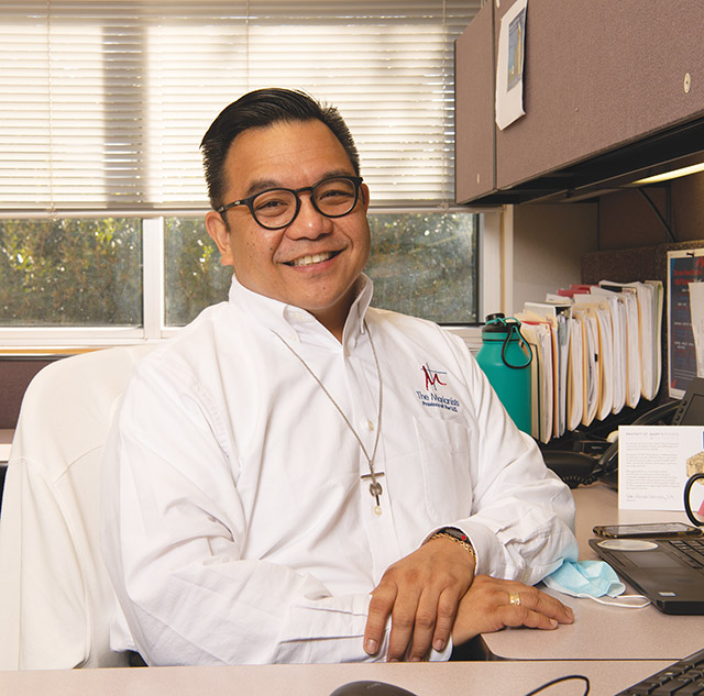 Br. Pacquing at his desk