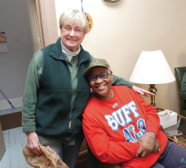 Sister Clare Ehmann, S.S.J. with a guest at St. Joseph’s Northside, a neighborhood drop-in center in Rochester, New York. 