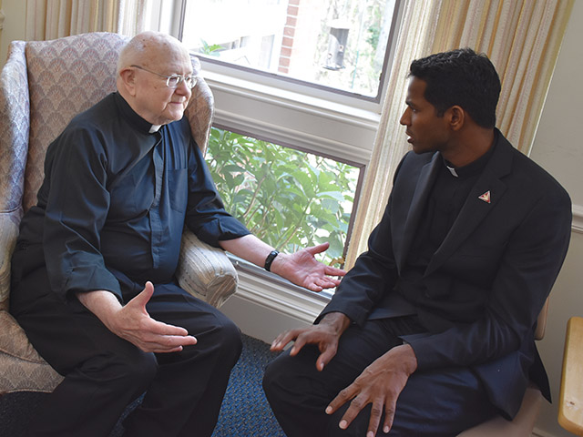  Father Edwin Dill, S.T. (left) and Father Aro Varnabas, S.T., members of the Missionary Servants of the Most Holy Trinity, sit and chat. 