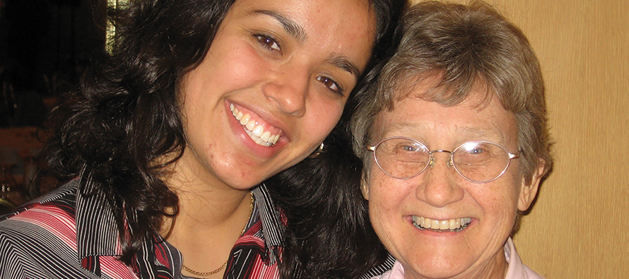 Younger and older sister smiling together