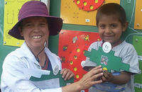 A young Escuela Móvil student is proud of his work, and Sister Ely Carrasco, C.D.P. is just as proud of him.