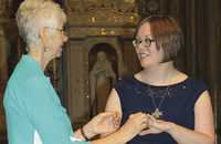 Sister Cecilia Corcoran, F.S.P.A. presents Sister Julia Walsh, F.S.P.A. with a ring during her final vows ceremony.