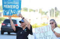 Sister Joni Luna, S.P. (left) takes part in a demonstration of solidarity with migrants, immigrants, and refugees.