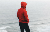 Man looks pensively out at a body of water