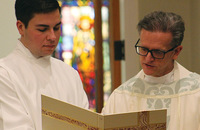 Father Paul English, C.S.B. reviews material prior to a liturgy.