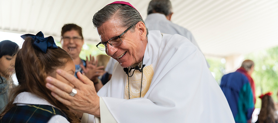 Archbishop Gustavo Garcia-Siller, M.Sp.S. talks and prays with a girl affected by the Uvalde massacre.